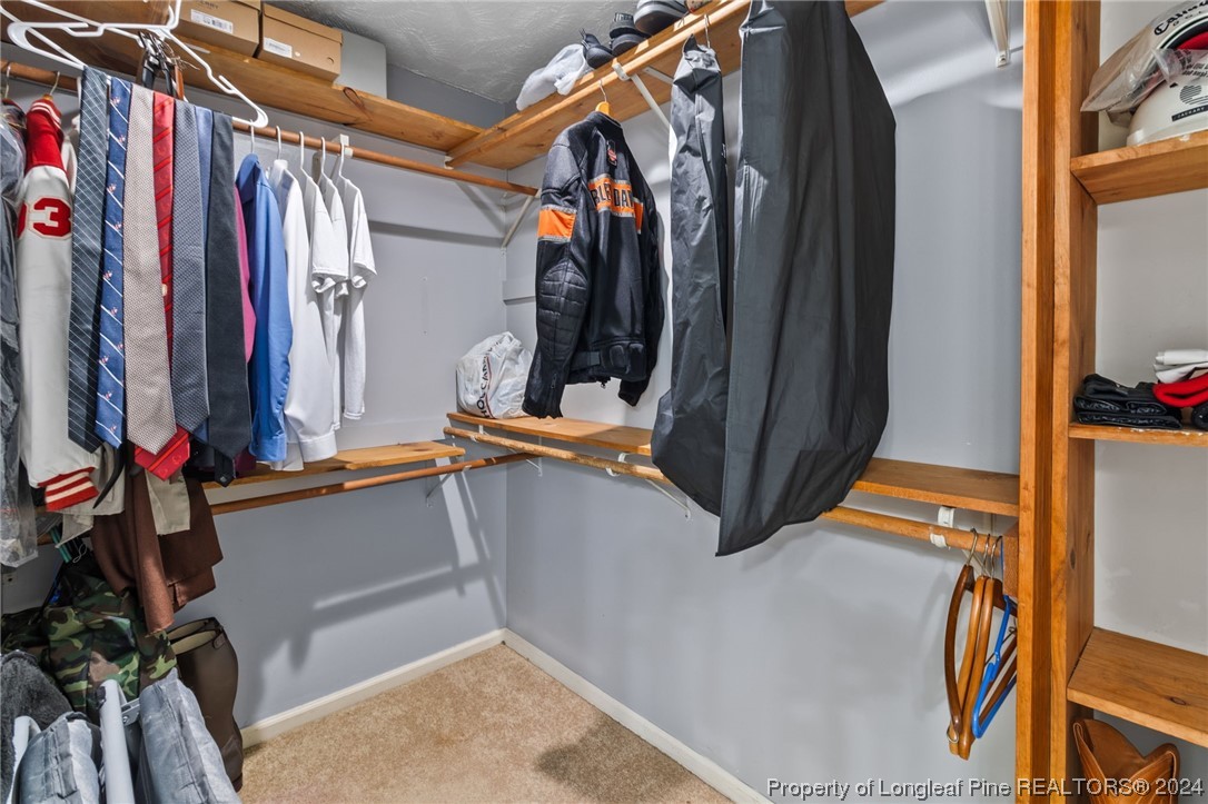 1177 Palestine Road Linden, NC 28356 - Photo 33 of 46 a view of walk in closet with clothes and shoes