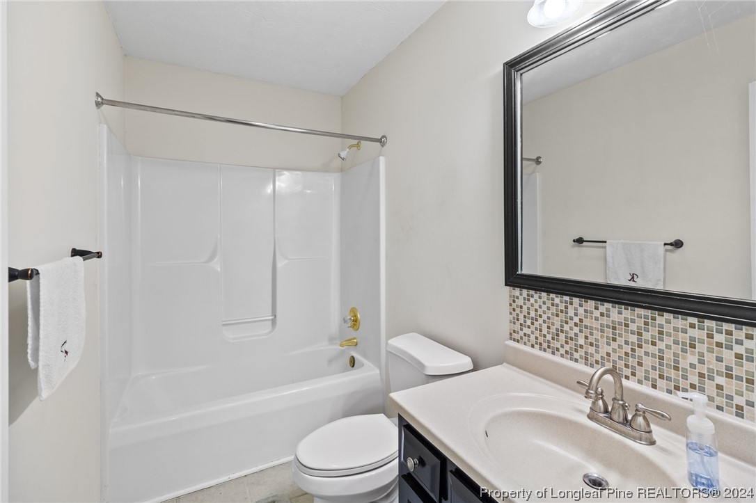 1177 Palestine Road Linden, NC 28356 - Photo 37 of 46 a bathroom with a sink toilet vanity and shower
