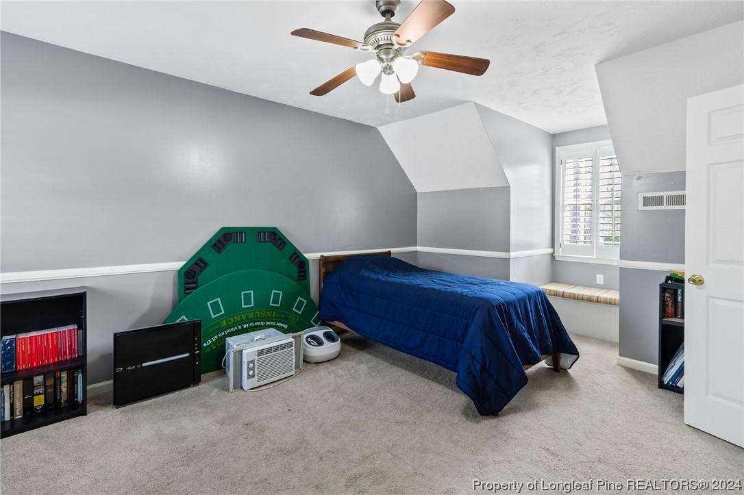 1177 Palestine Road Linden, NC 28356 - Photo 39 of 46 a bedroom with a bed and a chandelier