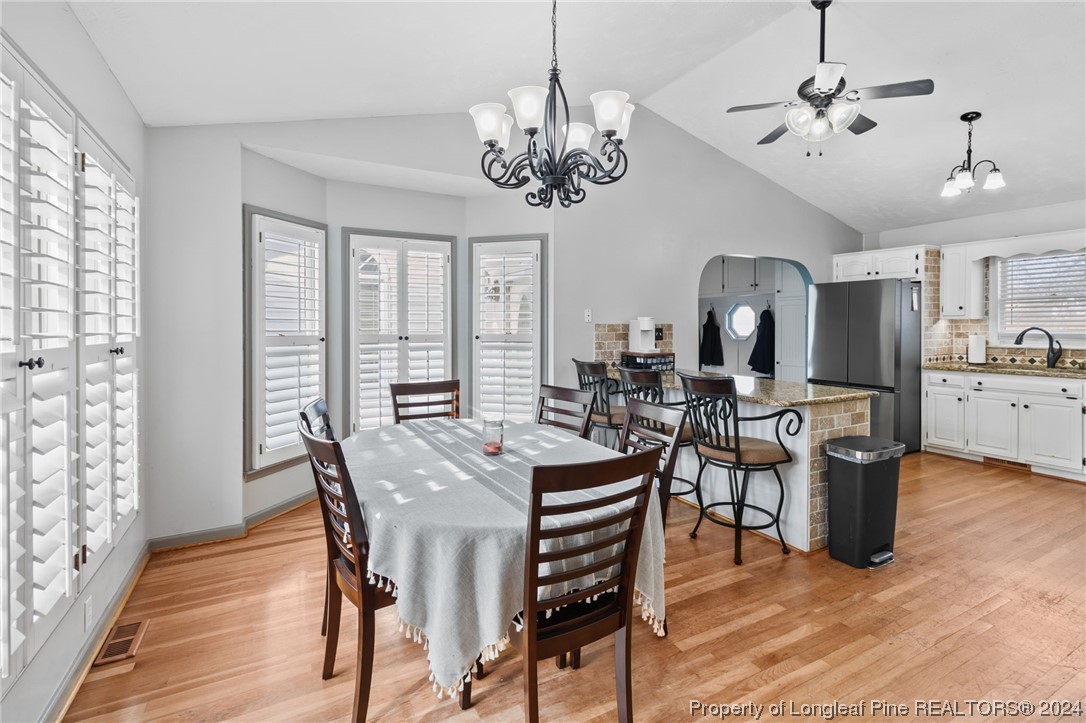1177 Palestine Road Linden, NC 28356 - Photo 7 of 46 a view of a dining room with furniture a chandelier and wooden floor