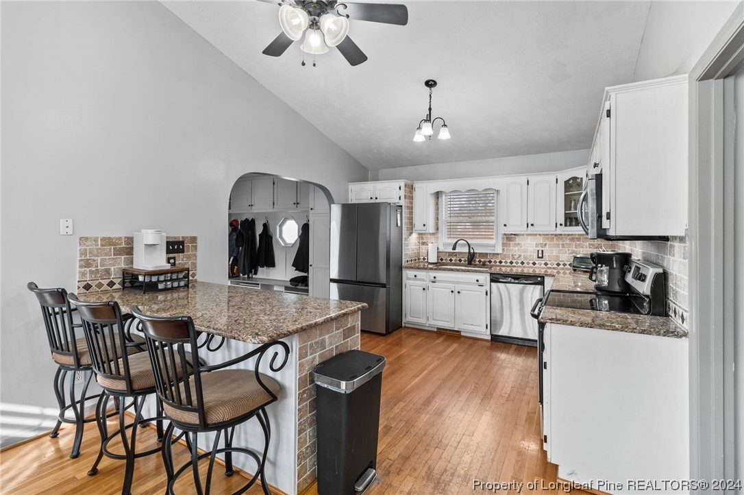 1177 Palestine Road Linden, NC 28356 - Photo 9 of 46 a kitchen with stainless steel appliances kitchen island granite countertop a table chairs and a refrigerator