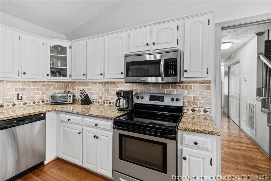 1177 Palestine Road Linden, NC 28356 - Photo 10 of 46 a kitchen with cabinets stainless steel appliances a sink and wooden floor