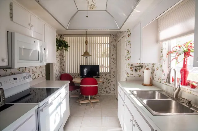 a kitchen with a sink stove and refrigerator