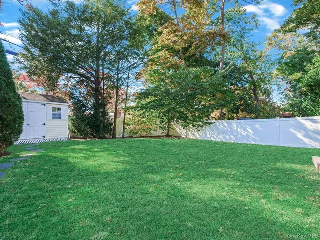 a view of a backyard with large trees