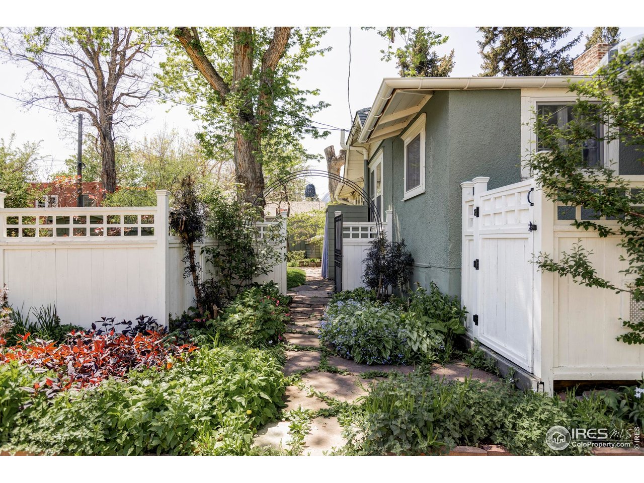 2424 4th Street Boulder, CO 80304 - Photo 27 of 29 a view of a house with a yard and fountain in middle of the road