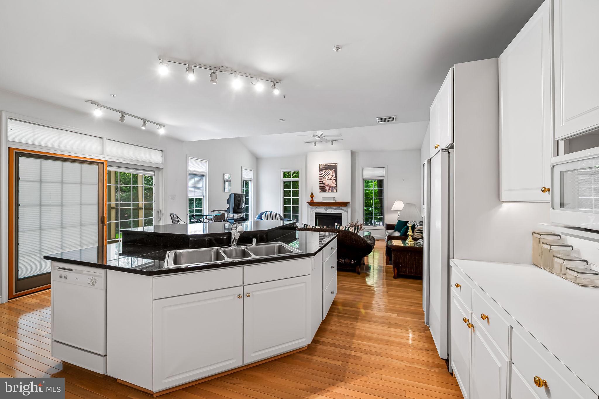 16 Roland Green, Unit 8 Baltimore, MD 21210 - Photo 16 of 55 a large white kitchen with a large counter top appliances and cabinets