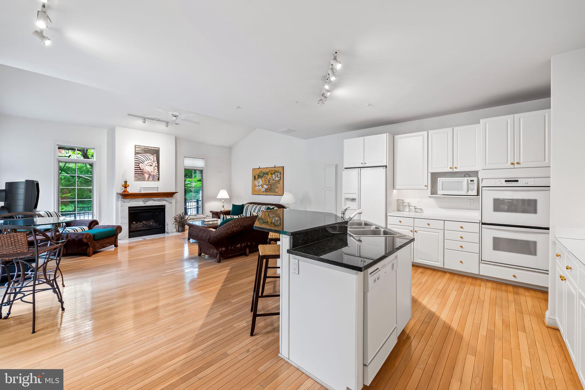 16 Roland Green, Unit 8 Baltimore, MD 21210 - Photo 17 of 55 a kitchen with a stove a refrigerator and a fireplace