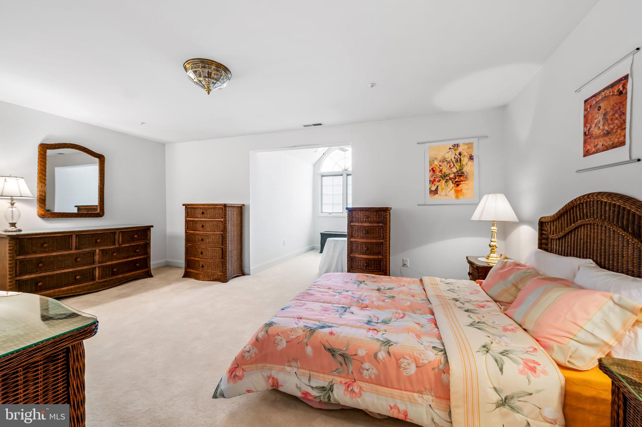 16 Roland Green, Unit 8 Baltimore, MD 21210 - Photo 37 of 55 a bedroom with a bed and dresser