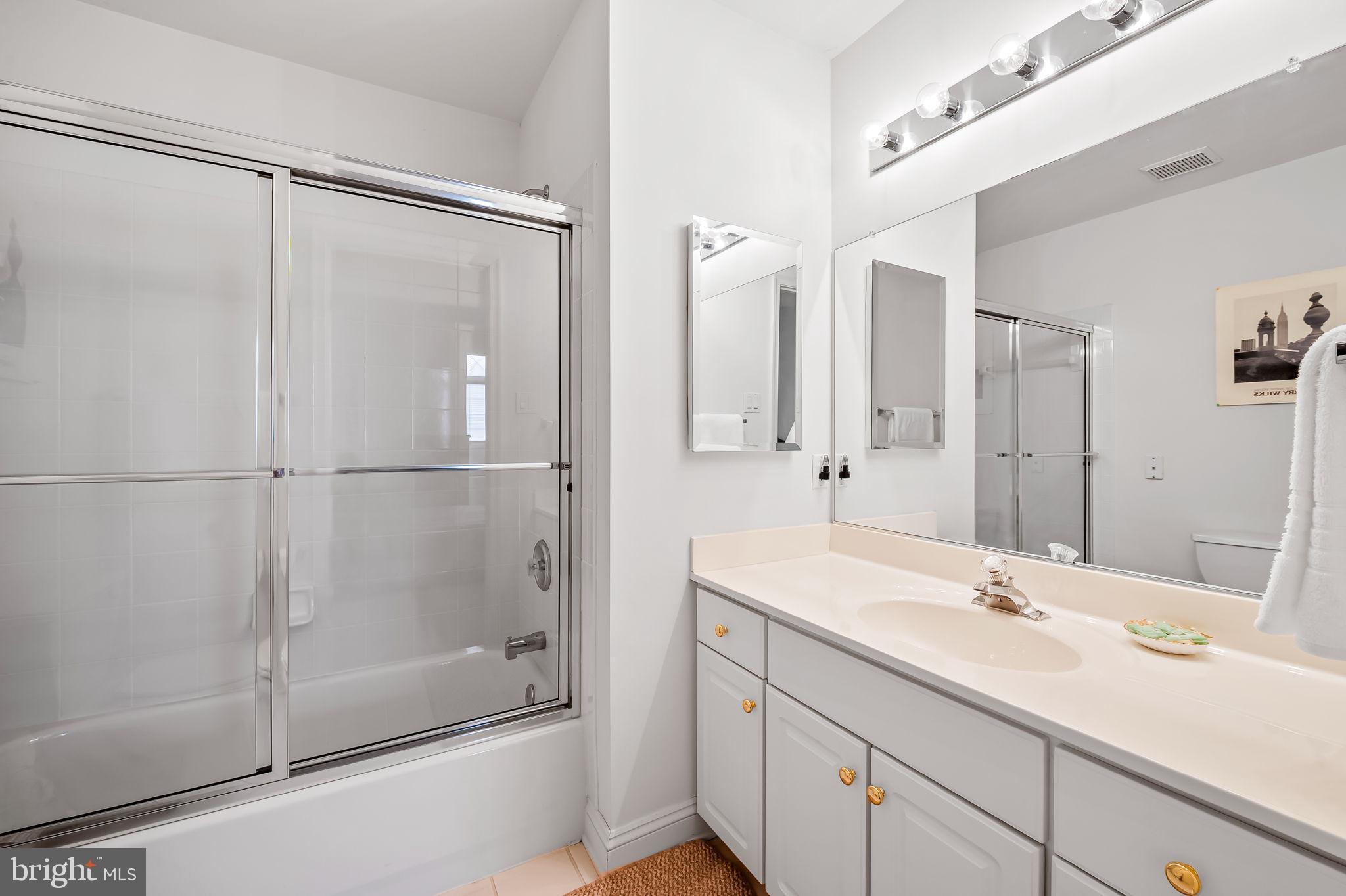 16 Roland Green, Unit 8 Baltimore, MD 21210 - Photo 38 of 55 a bathroom with a shower sink and mirror