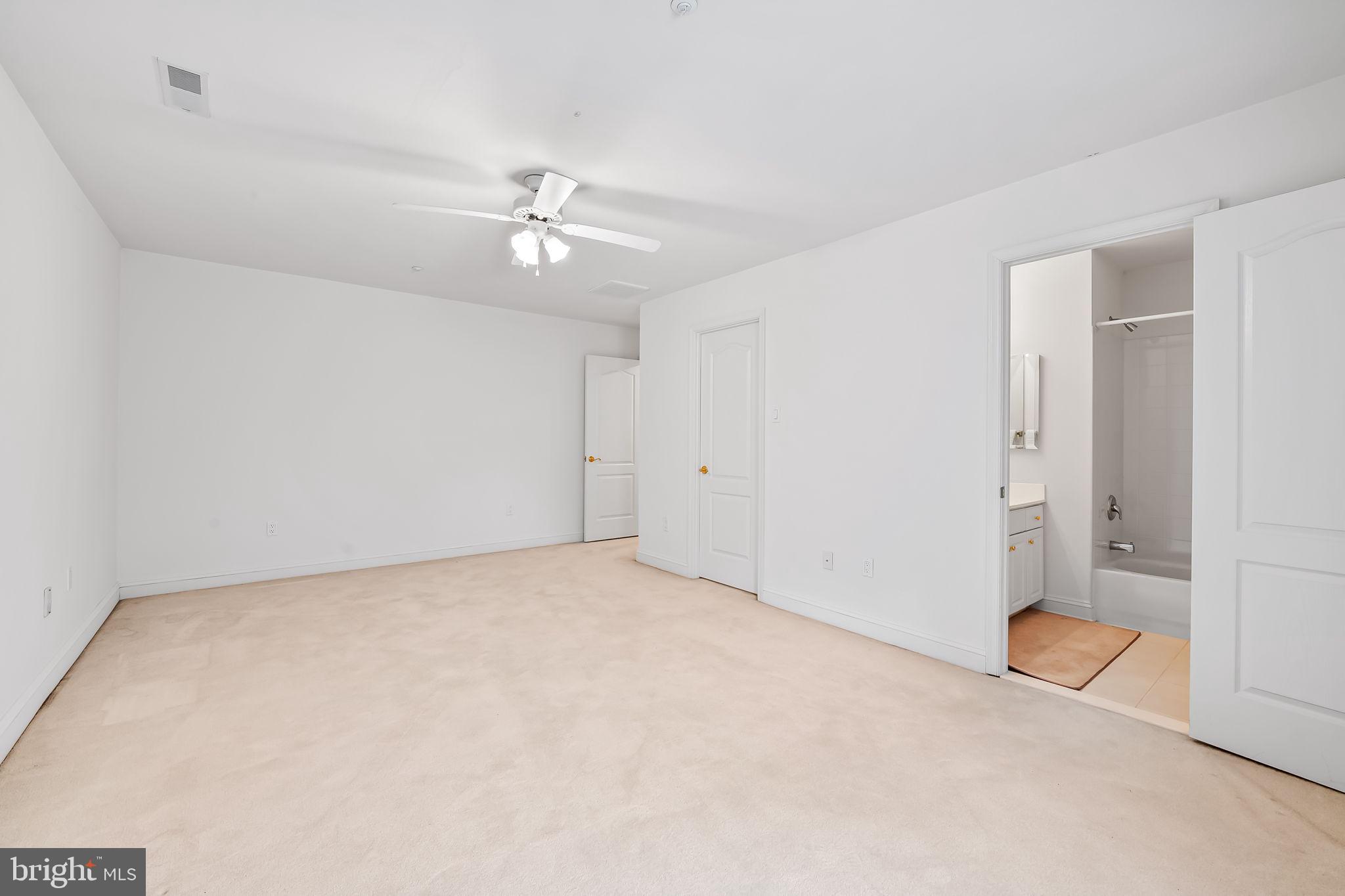 16 Roland Green, Unit 8 Baltimore, MD 21210 - Photo 40 of 55 an empty room with chandelier fan and windows