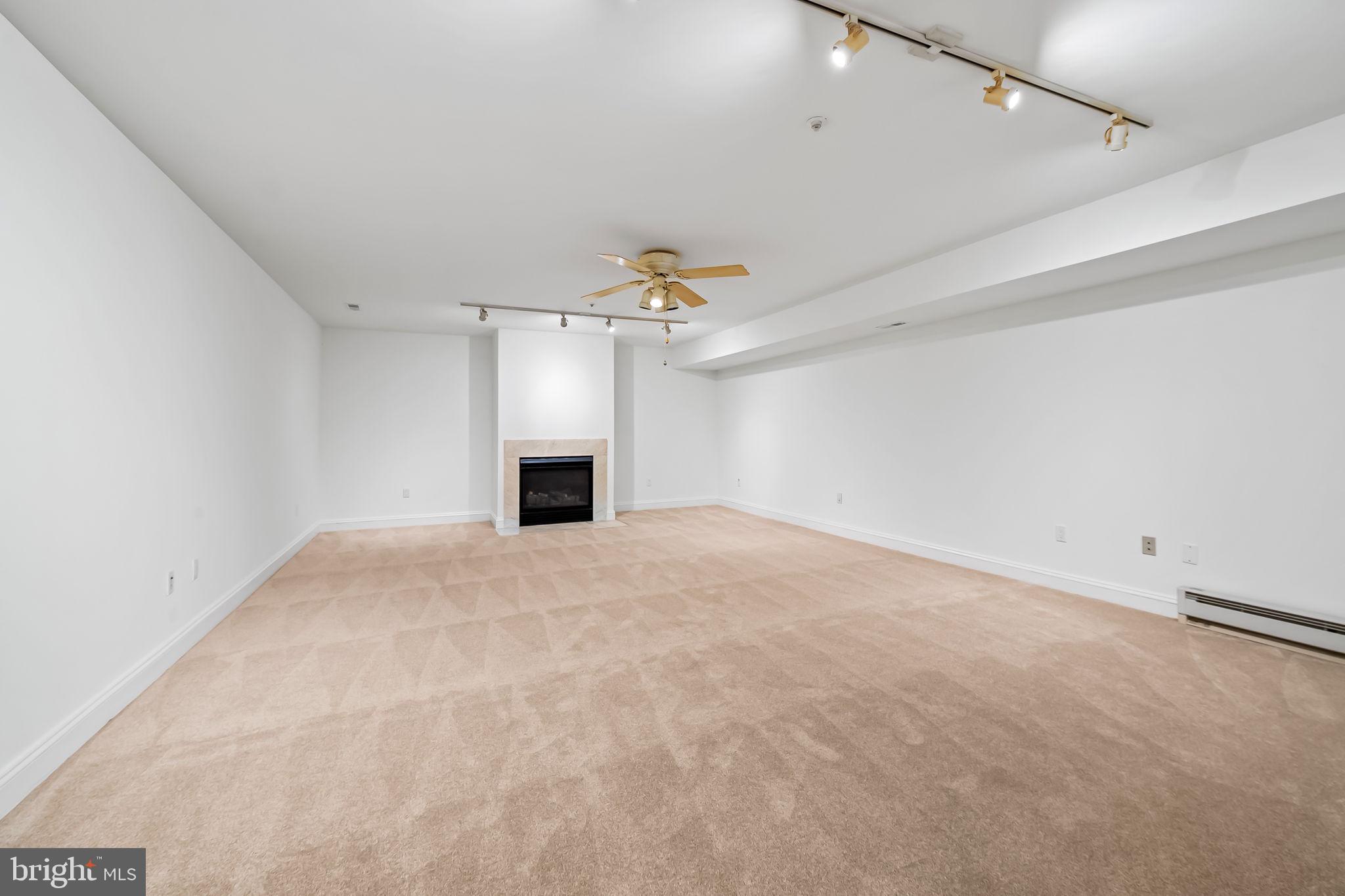 16 Roland Green, Unit 8 Baltimore, MD 21210 - Photo 43 of 55 a view of a livingroom with a ceiling fan and window
