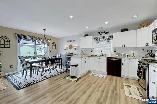 a kitchen with a sink appliances and cabinets