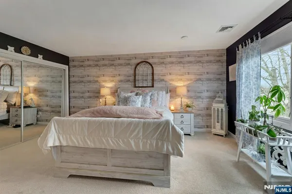 a bedroom with bed and window