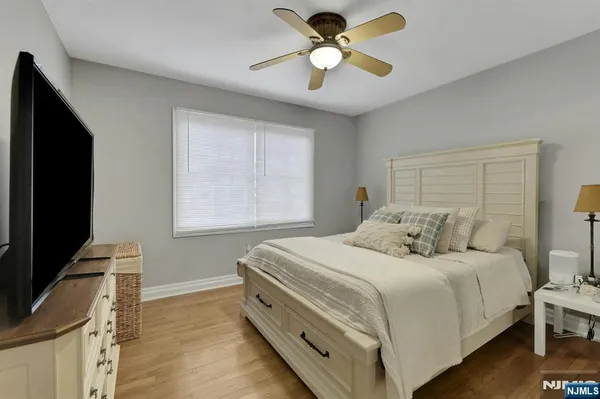a bedroom with furniture and a wooden floor