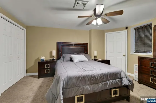 a bedroom with a large bed and a chandelier
