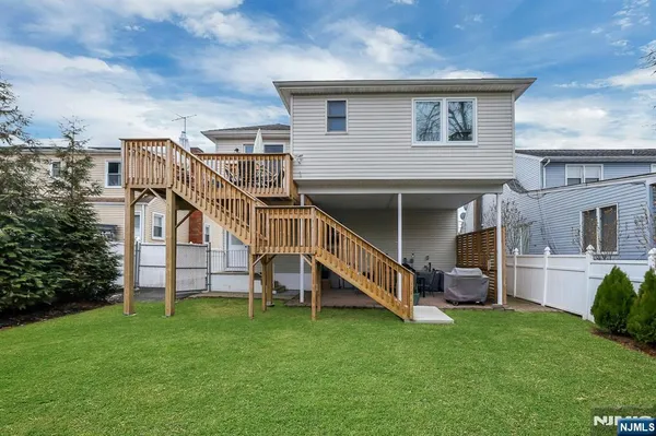 a view of a house with a yard and sitting area