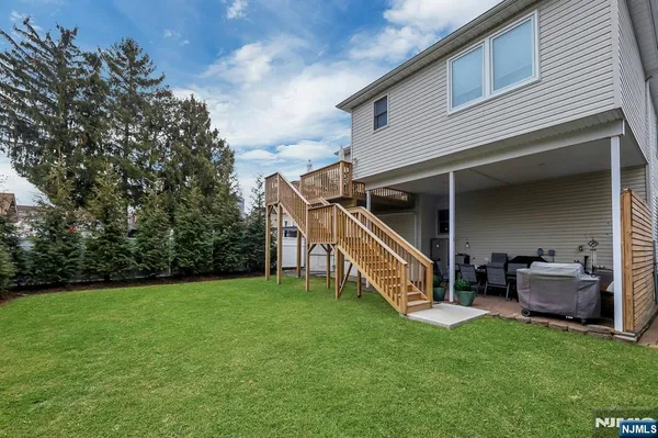 a view of a house with backyard and deck