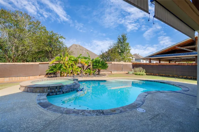 a view of a swimming pool with an outdoor seating
