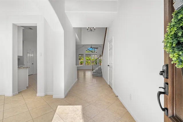 a view of hallway with furniture and a potted plant
