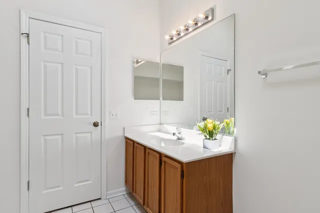 a bathroom with a sink vanity and a mirror