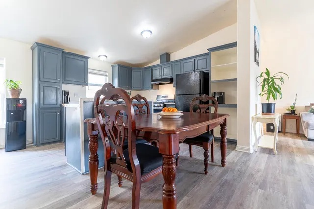 a view of a dining room with furniture and wooden floor