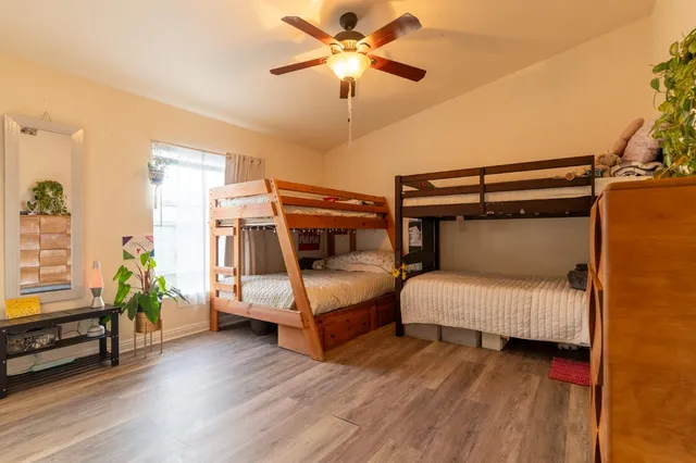 a bedroom with a bed and wooden floor