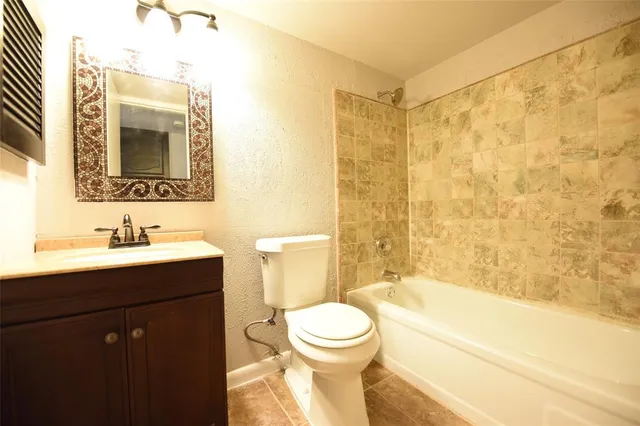 a view of a backyard with wooden fence and a large tree