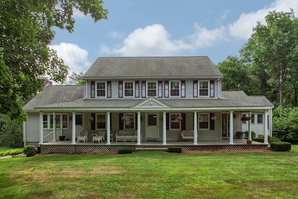 a big house with a big yard and potted plants