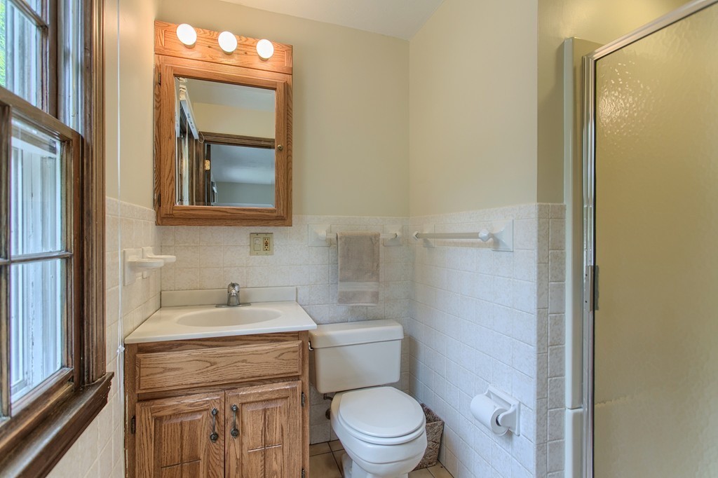 10 Farley Brook Road Chelmsford, MA 01824 - Photo 11 of 30 a bathroom with a toilet sink vanity and mirror