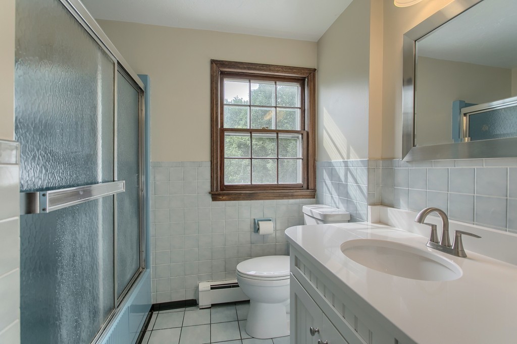 10 Farley Brook Road Chelmsford, MA 01824 - Photo 16 of 30 a bathroom with a toilet a sink a mirror and a window