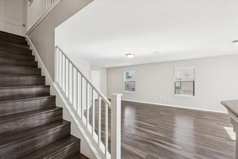 a view of staircase with wooden floor and a window