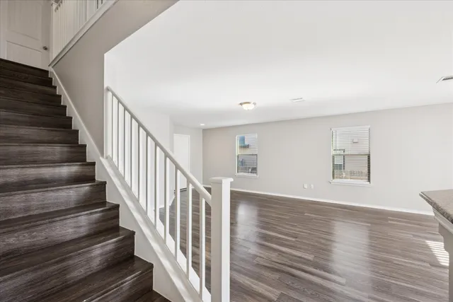 a view of staircase with wooden floor and a window