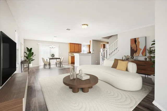a living room with furniture and a wooden floor