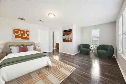 a bedroom with double bed and a couch