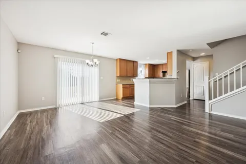 a view of a kitchen with wooden floor and a kitchen