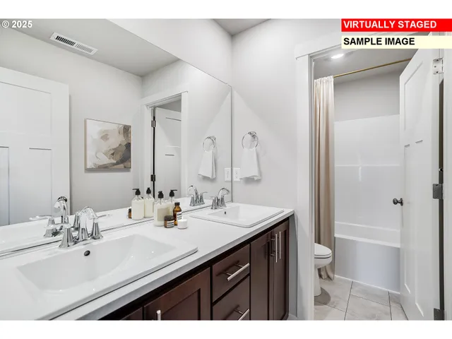 a bathroom with a sink double vanity and a mirror