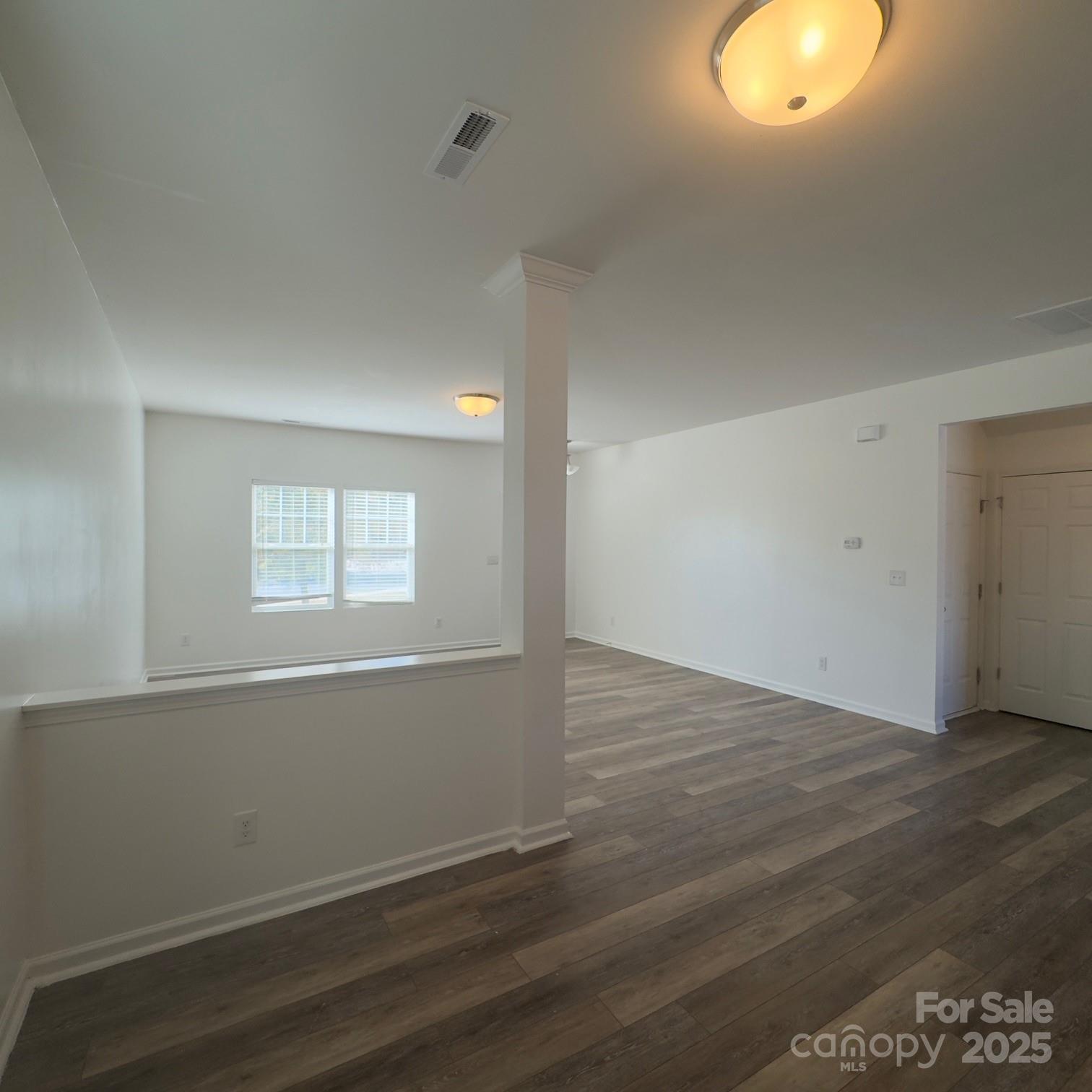 105 Abel Peterson Drive Mount Holly, NC 28120 - Photo 20 of 36 an empty room with wooden floor and windows
