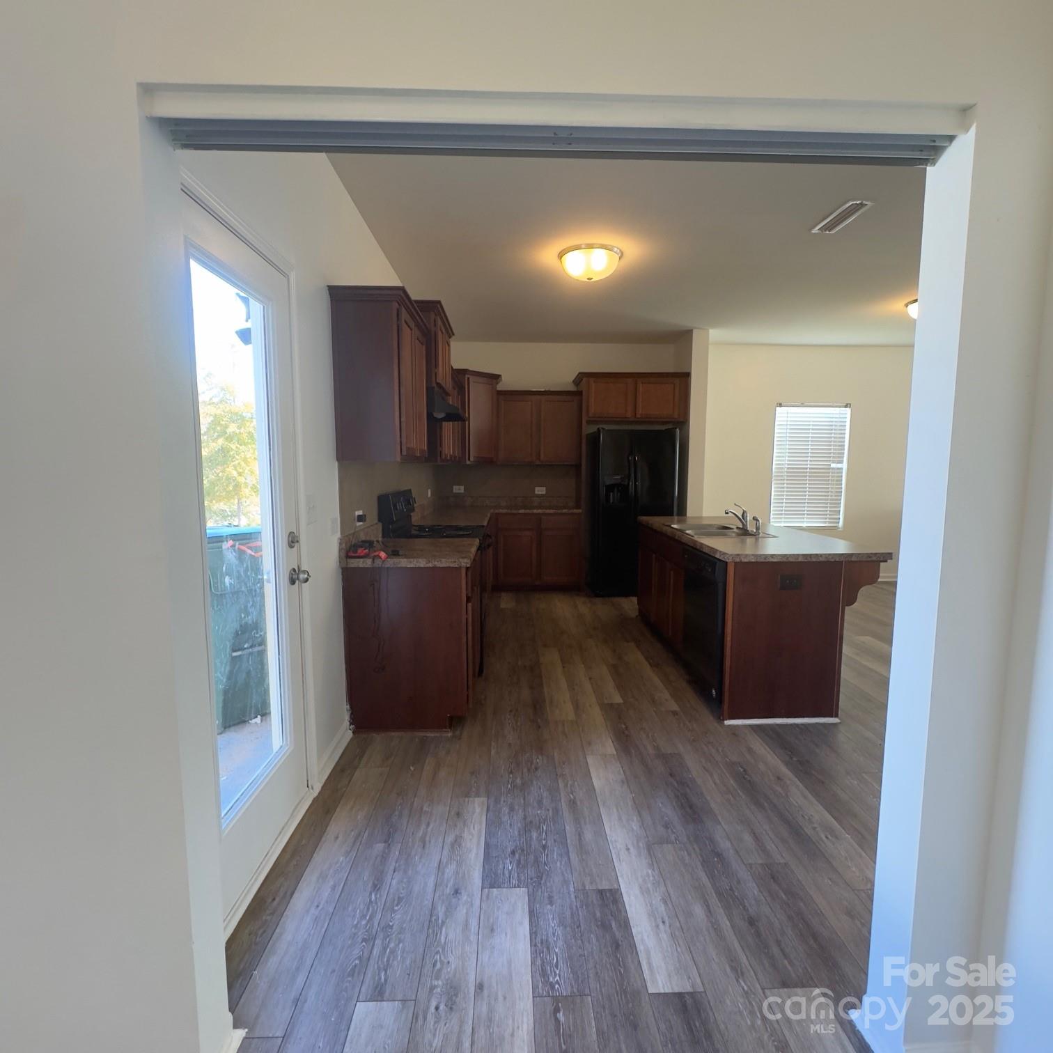 105 Abel Peterson Drive Mount Holly, NC 28120 - Photo 23 of 36 a kitchen with granite countertop a sink cabinets and wooden floor