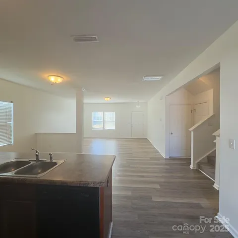 a view of a kitchen with a sink and cabinets