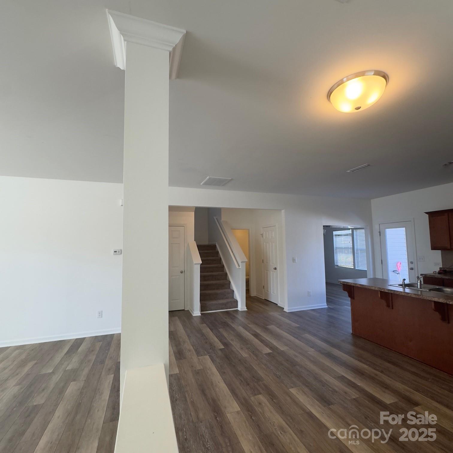 105 Abel Peterson Drive Mount Holly, NC 28120 - Photo 31 of 36 a view of a living room a room with wooden floor and a ceiling fan