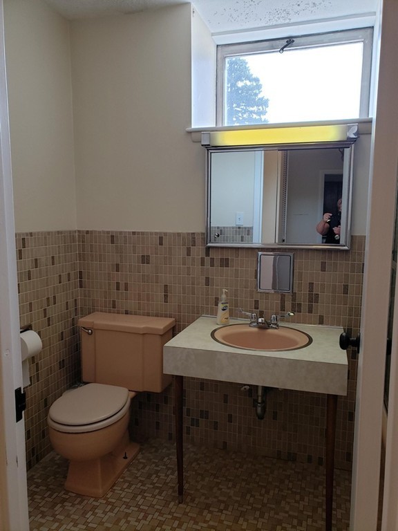 80 Salisbury Street, Unit 303 Worcester, MA 01609 - Photo 15 of 17 a bathroom with a toilet a sink and a mirror