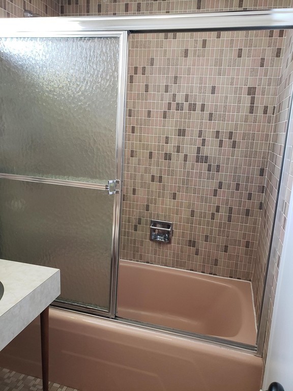 80 Salisbury Street, Unit 303 Worcester, MA 01609 - Photo 16 of 17 a bathroom with a bathtub and a shower