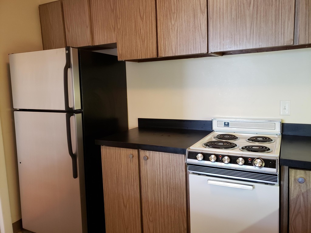 80 Salisbury Street, Unit 303 Worcester, MA 01609 - Photo 6 of 17 a white refrigerator freezer and a stove sitting inside of a kitchen