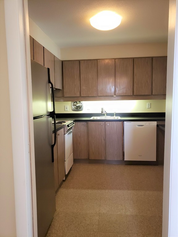 80 Salisbury Street, Unit 303 Worcester, MA 01609 - Photo 7 of 17 a kitchen with stainless steel appliances granite countertop a sink a stove a refrigerator a microwave and cabinets