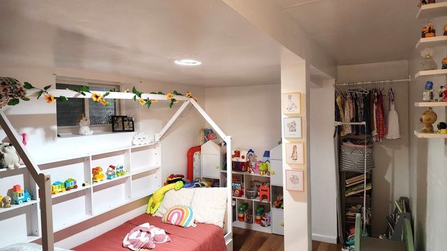 a bed room with a bed and a television