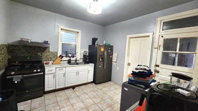 a kitchen with a sink appliances and cabinets