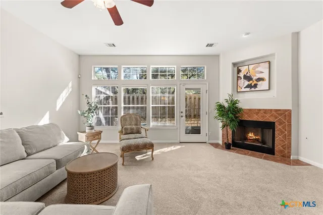 a living room with furniture and a fireplace
