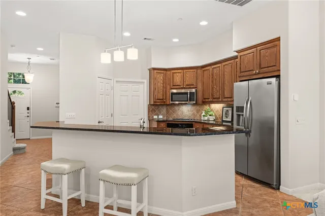 a living room with furniture and kitchen view
