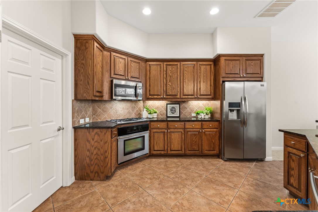 10300 Morado Cove, Unit 503 Austin, TX 78759 - Photo 14 of 33 The kitchen features stainless steel appliances and granite countertops.