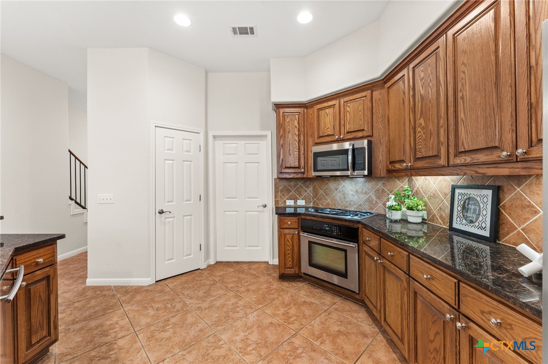 10300 Morado Cove, Unit 503 Austin, TX 78759 - Photo 15 of 33 The doors ahead are a pantry and laundry room.
